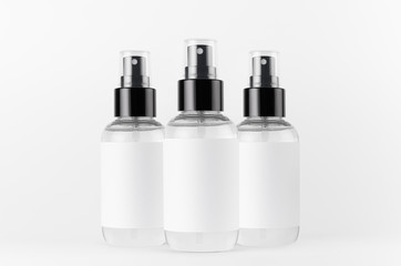 Transparent spray bottles for cosmetics product with white blank label on white background, mock up for branding, advertising, presentation, design.
