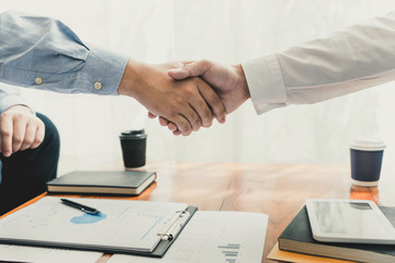 Business Meeting agreement Handshake concept, Hand holding after finishing up dealing project or bargain success at negotiation over office background