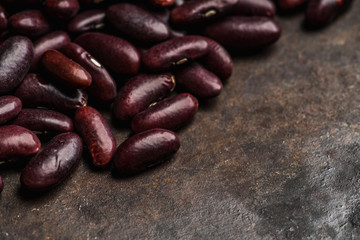 Purple beans on the rustic background. Selective focus. Shallow depth of field.