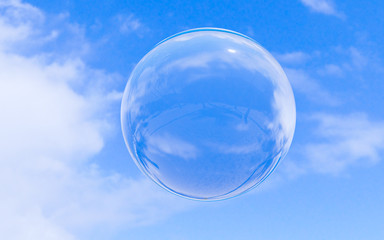 Bubble soap on blue sky with clouds background texture in bright morning. 3d ball, round circle. Transparent glass sphere for clean atmosphere. Nature abstract white cloudscape in sunny day.