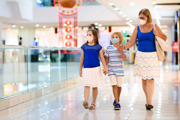 Fototapeta na wymiar Family wearing face mask in shopping mall in Asia