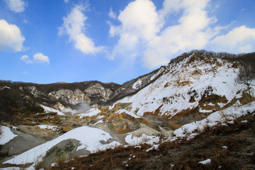 Fototapeta na wymiar Snow mountain with blue sky in Hokkaido, Japan