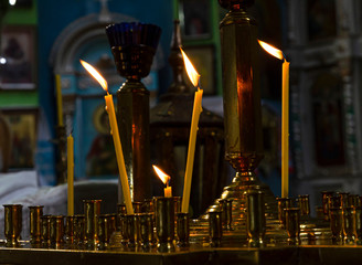 religious tradition, a symbol of the Christian faith, a wax candle burns with an even flame, a smoke from an extinguished wick