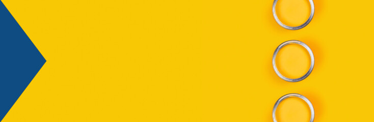 Repair concept. Yellow background with three color paint cans. Flat lay, top view, copy space.