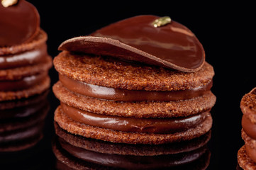 Original chocolate cake. Black background.Close-up.