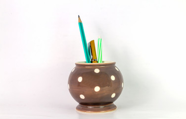 Pen and pencil jar on white background