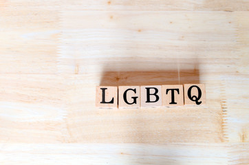 LGBTQ concept idea, wooden letters connect to message on wooden desk, informative and communication about alternative gender groups consisting of Lesbian, Gay, Bisexual, Transgender and Queer