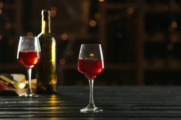 Glass of delicious wine on table in bar