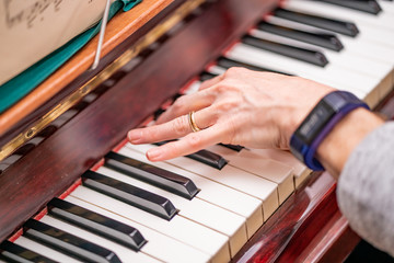 Obraz premium Human hand playing the piano with selective focus on finger tips