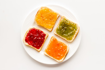 Fototapeta na wymiar Toast with colorful fruit jam frame on white background