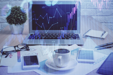 Forex market graph hologram and personal computer on background. Double exposure. Concept of investment.