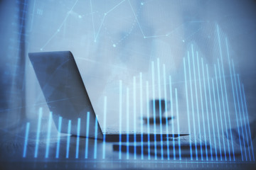 Double exposure of graph and financial info and work space with computer background. Concept of international online trading.