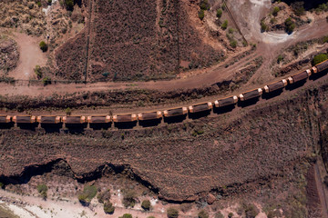 Overhead view of industrial railway cars loaded with iron ore ready for transportation, captured at Whyalla in South Australia