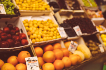 Blurred background with market stall with fresh different fruits