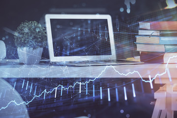 Stock market graph and table with computer background. Multi exposure. Concept of financial analysis.