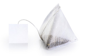 Tea bag with white label isolated on white background.