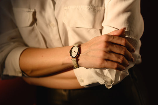 close up fashion details, young business woman wearing golden watch and white shirt. ideal fall outfit accessories.