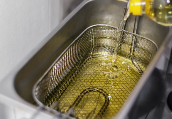 Fresh Cooking Oil Pouring into Deep Fryer.