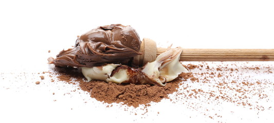 Chocolate and vanilla cream spread with wooden dipper and cocoa powder isolated on white background