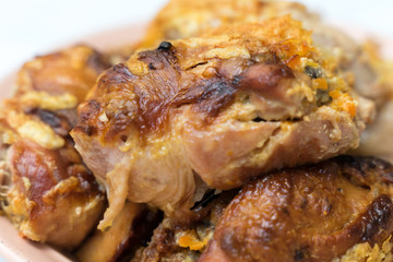 pieces of appetizing fried chicken close-up with a crispy crust lie on a plate
