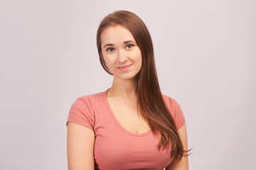 Fototapeta premium Young beautiful girl isolated on white background in Studio. Woman looks with calm expression, People, natural beauty and concept of youth