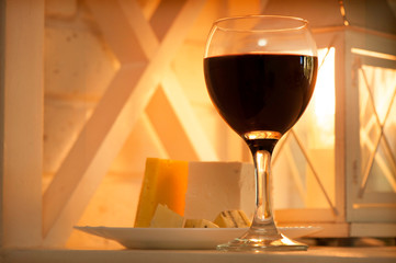 Shelf with a glass of wine and a plate of cheese