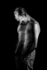 Naklejka premium lyrical romantic guy bowed his head. depressed pensive mood. ghosts from the past. monochrome black and white stylish naked torso young sexy man portrait. Creative design