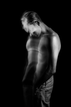 lyrical romantic guy bowed his head. depressed pensive mood. ghosts from the past. monochrome black and white stylish naked torso young sexy man portrait. Creative design