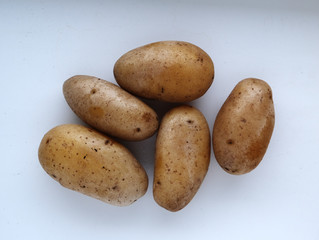 boiled potatoes in a peel on a white background