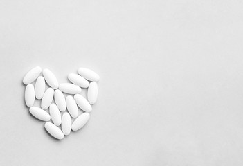 Medicine pills, tablets and capsules for the treatment of heart disease on gray