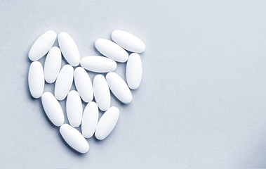 Medicine pills, tablets and capsules for the treatment of heart disease on gray