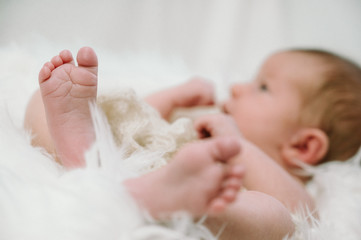 Feet of a newborn baby in the hands of parents. Happy family moment and concept.