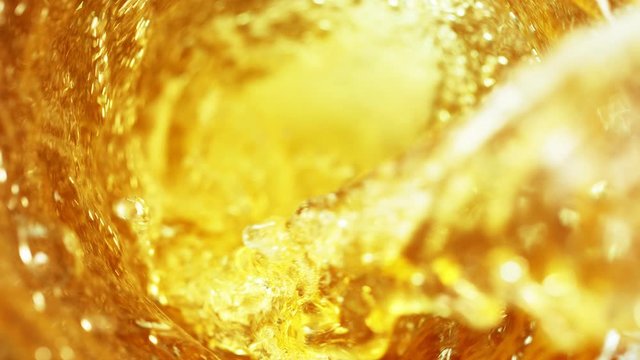 Super slow motion of pouring cola/whiskey or ice tea drink in twister shape. Filmed on high speed cinema camera, 1000 fps.