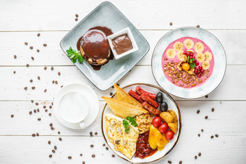 delicious breakfast. coffee, crepes and porridge for breakfast. breakfast on a white background