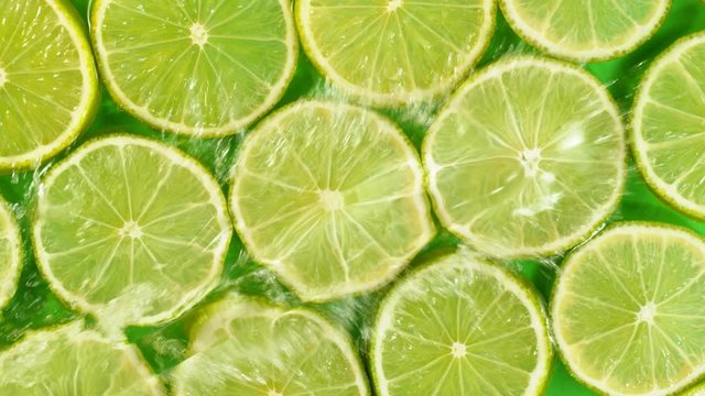 Super slow motion of lime slices with splashing water. Filmed on high speed cinema camera, 1000 fps.
