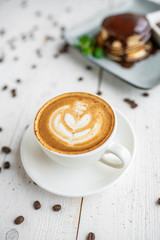 cup of cappuccino on a white wooden table