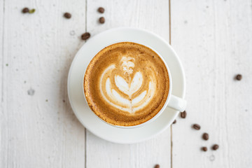 cup of cappuccino on a white wooden table