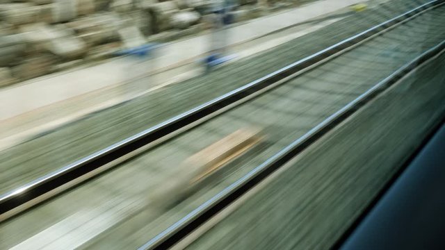 View on railroad track from the window of fast train. Bullet train rides on the railway track. 4K