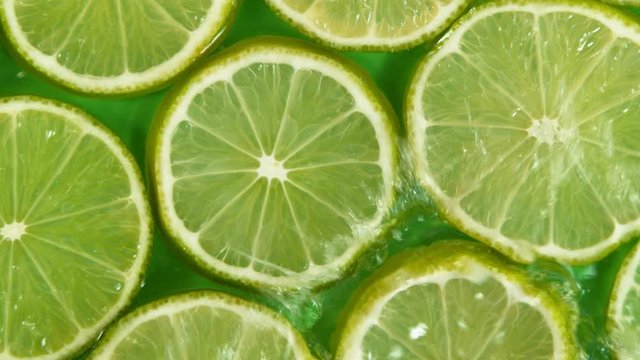 Super slow motion of lime slices with splashing water. Filmed on high speed cinema camera, 1000 fps.