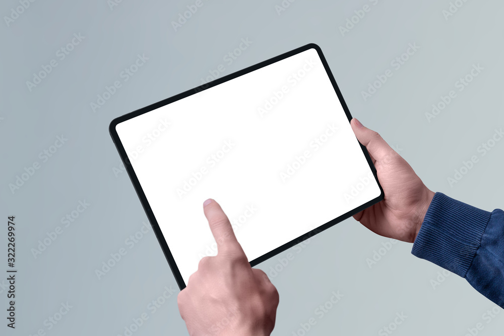 Aufkleber Tablet mockup in horizontal position in man hand. Left hand touch isolated screen concept