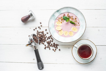 coffee grains in a coffee machine horn. on a white wooden background