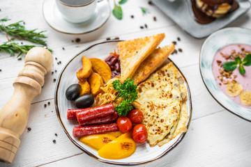 delicious breakfast. coffee, crepes and porridge for breakfast. breakfast on a white background