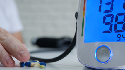 Image with a Suffering Person Taking Drugs and Pills for Blood Pressure Disease