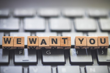 Hiring and recruiting concept: “We want you” letters on black keyboard.