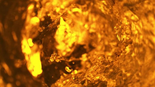 Super slow motion of pouring cola/whiskey or ice tea drink in twister shape. Filmed on high speed cinema camera, 1000 fps.
