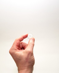 big white pill in hand on a white background