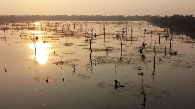 Sunset over a moat in Angkor ; drone view over a huge moat near Preah Khan temple, Siem Reap, Cambodia