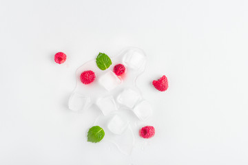 Ice cubes with raspberries and mint leaf on wooden table. Homemade skincare hydrating ice cubes. Close up, copy space for text