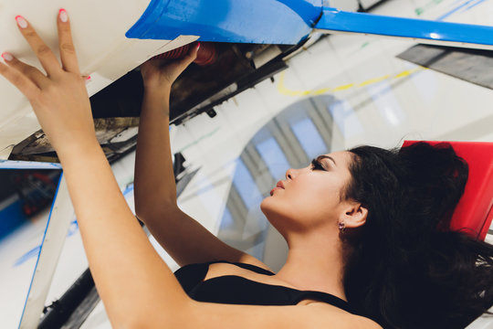 Female Helicopter Maintenance Worker Engineer Maintaining A Heavy.