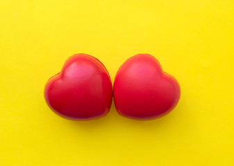 Two hearts isolated on a yellow background